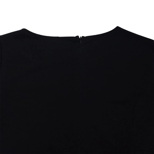 Detail shot of a black dress featuring a round neckline and hidden back zipper closure
