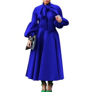 Detail of royal blue dress with large neck bow and elegant puff lantern sleeves