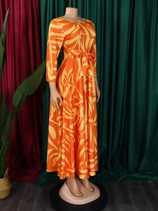 Detailed view of the waist-tie bow and vibrant tropical leaf print on this maxi dress