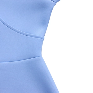 Detailed close-up of light blue knit dress waistline with precise stitching and fabric texture
