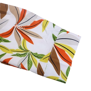 Close-up of long sleeve cuff with tropical leaf print and precise white stitching detail