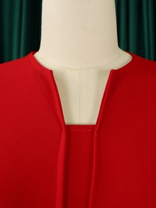Close-up detail of V-neckline and high-quality red chiffon fabric on the dress