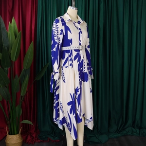 Detailed view of the irregular hem and floral pattern on this long sleeve shirt dress
