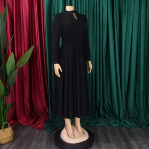 Detail of elegant black long sleeve dress with waist wrap pleats and neckline cutout
