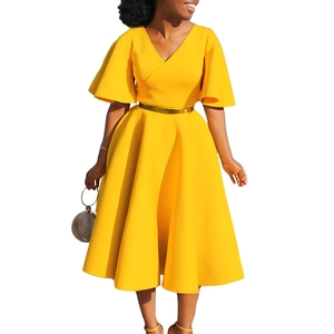 Detail of elegant yellow V-neck dress with flared sleeves and a gold metallic belt