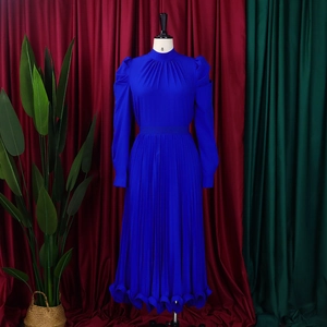 Detailed macro shot of fine pleated texture and lettuce hem on royal blue sleeve