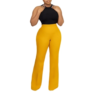 Detail of high-waisted yellow wide-leg trousers paired with a black ribbed knit tank top
