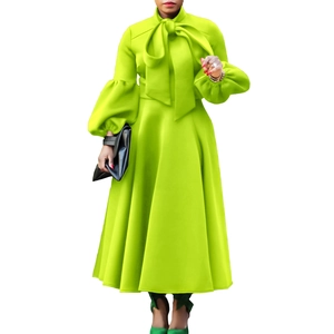 Close-up of elegant lantern sleeves and high waist bow tie on neon green maxi dress