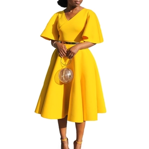 Detail of yellow V-neck dress with flare sleeves and metallic gold waist belt