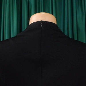 Detail shot of the back neckline featuring a hidden zipper on a black plus size dress
