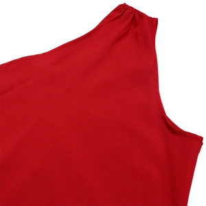 Detail of red one-shoulder dress showing pleated shoulder seam and high-quality fabric texture