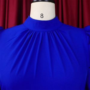 Close-up of royal blue blouse featuring elegant pleated neckline and puff sleeve details