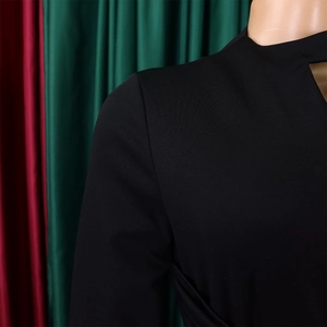 Close-up of the elegant hollow neckline and pleated texture on a black plus size dress