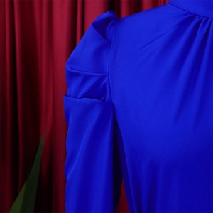 Detail of royal blue puff sleeves and pleated stitching on a chic two-piece women set