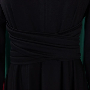 Detail shot of the crossover wrap waist design and premium pleated fabric on this black dress