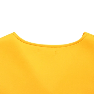 Detailed close-up of the round neckline and stitching on this yellow flared sleeve dress
