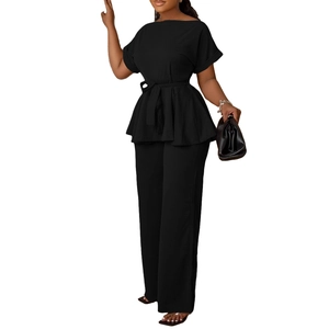 Détail d'un ensemble chic deux pièces noir avec haut ceinturé et pantalon large