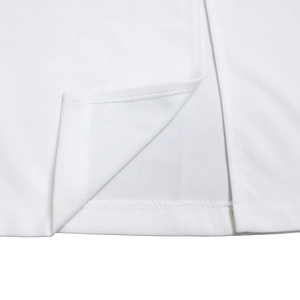 Detailed close-up of the side slit and hem stitching on a white knit bodycon dress
