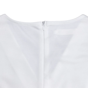 Detail view of the white dress featuring a textured fabric and hidden back zipper