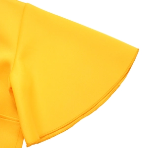 Detailed close-up of flared sleeves and precise edge stitching on a yellow dress
