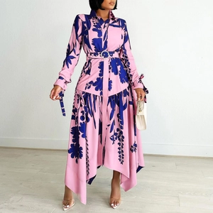 Detail of pink floral shirt dress featuring asymmetric hem and decorative waist belt