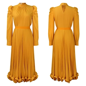 Detail of ginger yellow pleated dress set with puff sleeves and accordion skirt hem