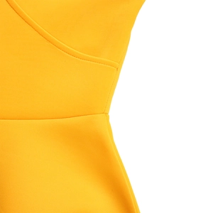 Close-up of bright yellow dress showing V-neck tailoring and neat waist stitching