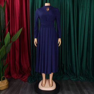 Close-up of dark blue pleated dress featuring a hollow neckline and waist wrap detail