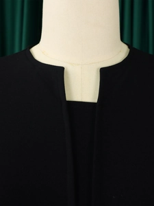 Detail shot of a black V-neck dress with ruffle trim and high waist on a mannequin