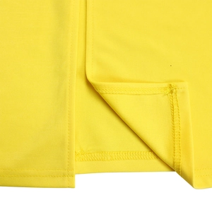 Detail of fine stitching and vibrant yellow fabric texture on the elegant pencil dress