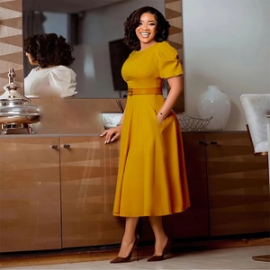 Detail of elegant yellow A-line dress with belted waist and metallic buckle detail