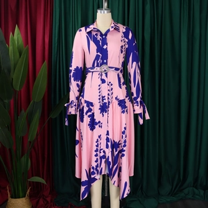 Detail of pink floral shirt dress featuring button front, waist belt and bow tie cuffs