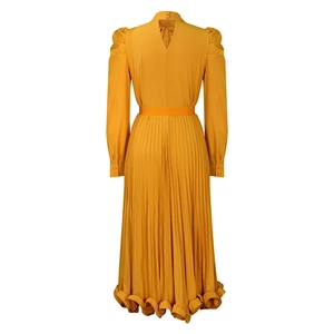 Detail of yellow pleated dress back with teardrop cutout and bubble sleeves texture