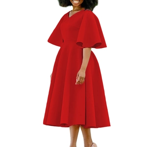 Detail of red V-neck dress featuring oversized flare sleeves and an A-line pleated skirt