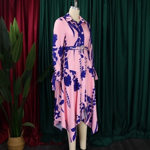 Detail of pink floral dress featuring shirt collar, buttoned front and belted waist design