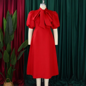 Detail of red party dress showing oversized bow neckline and vintage puff sleeves