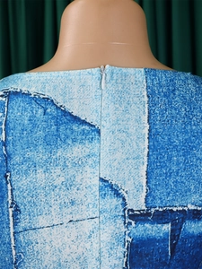 Detailed view of dress back neckline featuring blue pattern print and white hidden zipper