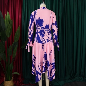 Detail of floral print maxi dress featuring cinched waist and elegant ruffled hemline