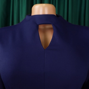 Detailed view of the navy blue dress featuring a teardrop cutout and textured fabric