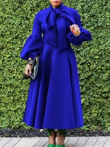 Elegant royal blue A-line dress featuring lantern sleeves and a bow-tie neckline