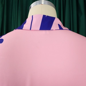 Detail of pink floral dress back with blue abstract print and lapel collar stitching