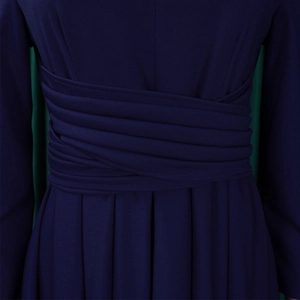 Detailed macro shot of deep navy pleated dress waist with criss-cross ruched design