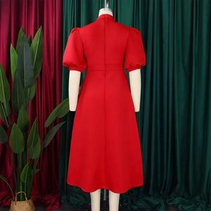 Detailed back view of a red puff sleeve banquet dress with invisible zipper on a mannequin