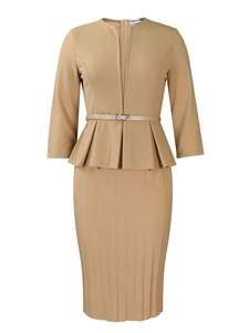 Detailed macro view of the elegant peplum waist with slim belt on camel pencil dress