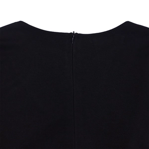 Close-up of invisible zipper and woven texture on black V-neck pencil dress back