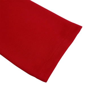 Detail of red knit dress sleeve showing high-quality stitching and cotton fabric texture