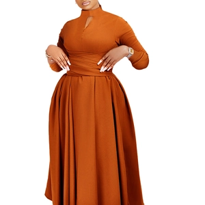 Detail of caramel pleated dress with high neck, cutout chest, and slim waist design