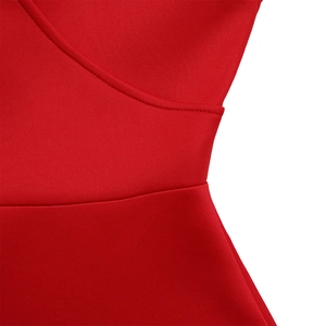 Detailed close-up of the waist stitching and vibrant red fabric of this elegant dress