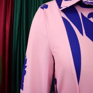 Detail of pink and navy blue leaf print fabric on large size dress with lapel collar