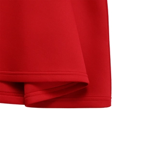 Close-up of double-needle stitched hem on a red flared dress made of thick premium fabric